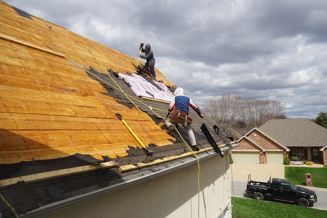 men repairing a roof